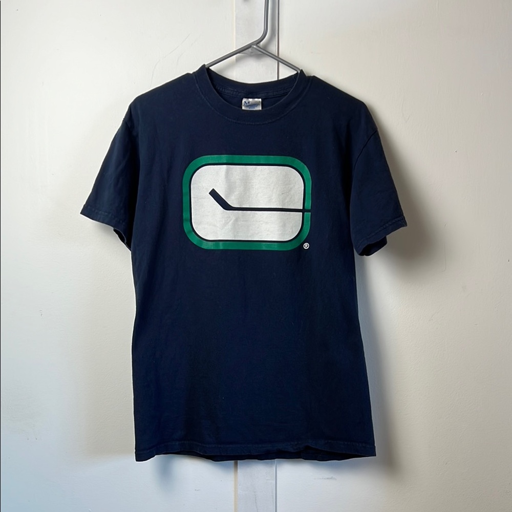 Canucks Hockey Stuck Logo Dark Blue Tee with Green and White Print